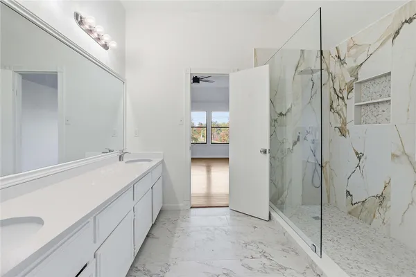 a spacious bathroom with a double vanity sink and a shower