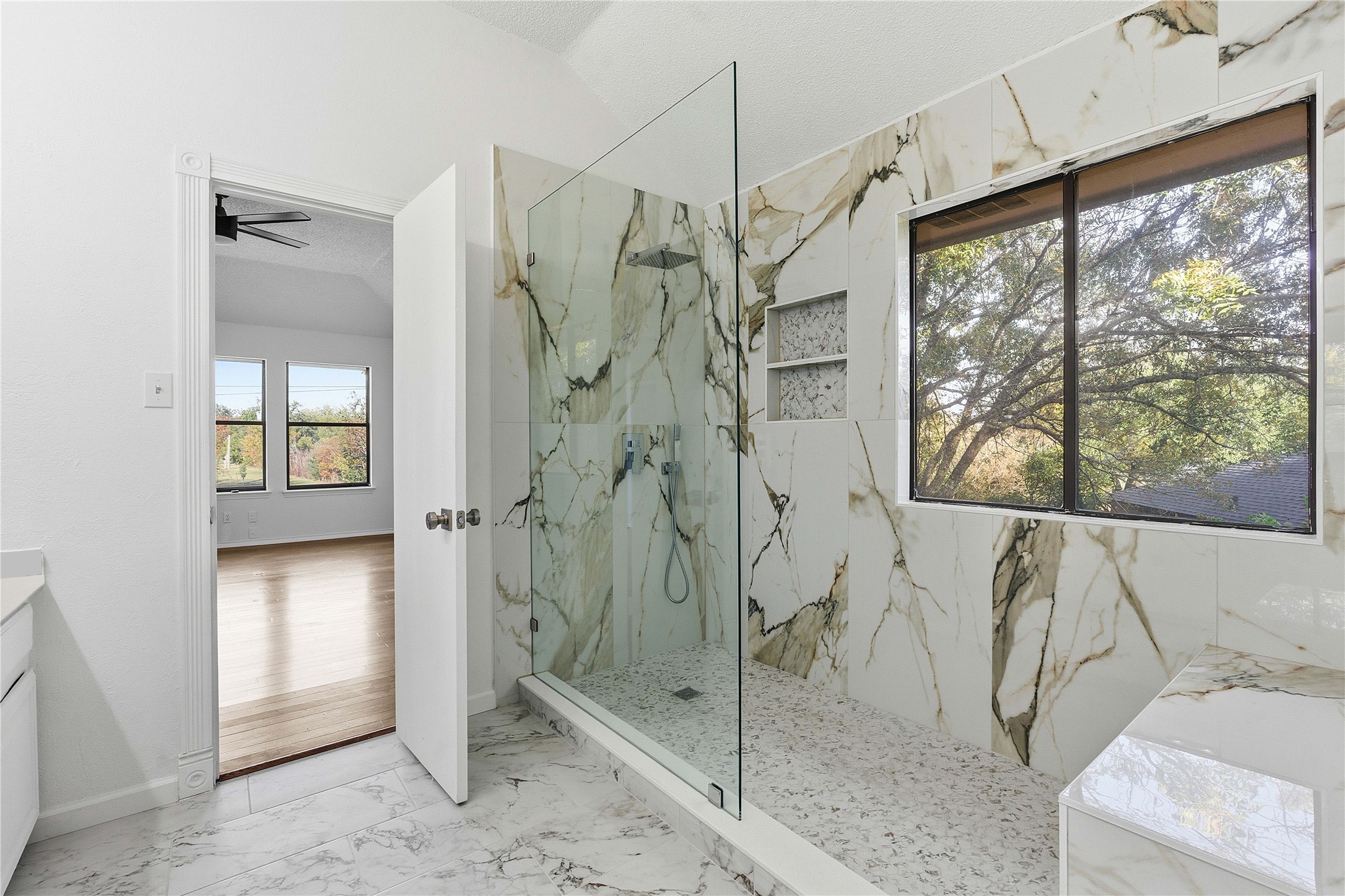 1106 Split Oak Cove Pflugerville, TX 78660 - Photo 12 of 25 Bathroom featuring a marble finish shower, plenty of natural light, marble finish floors, vaulted ceiling, and vanity