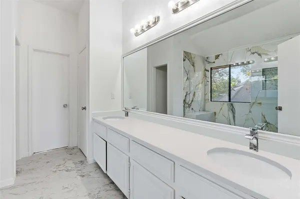 a bathroom with a double vanity sink mirror and double