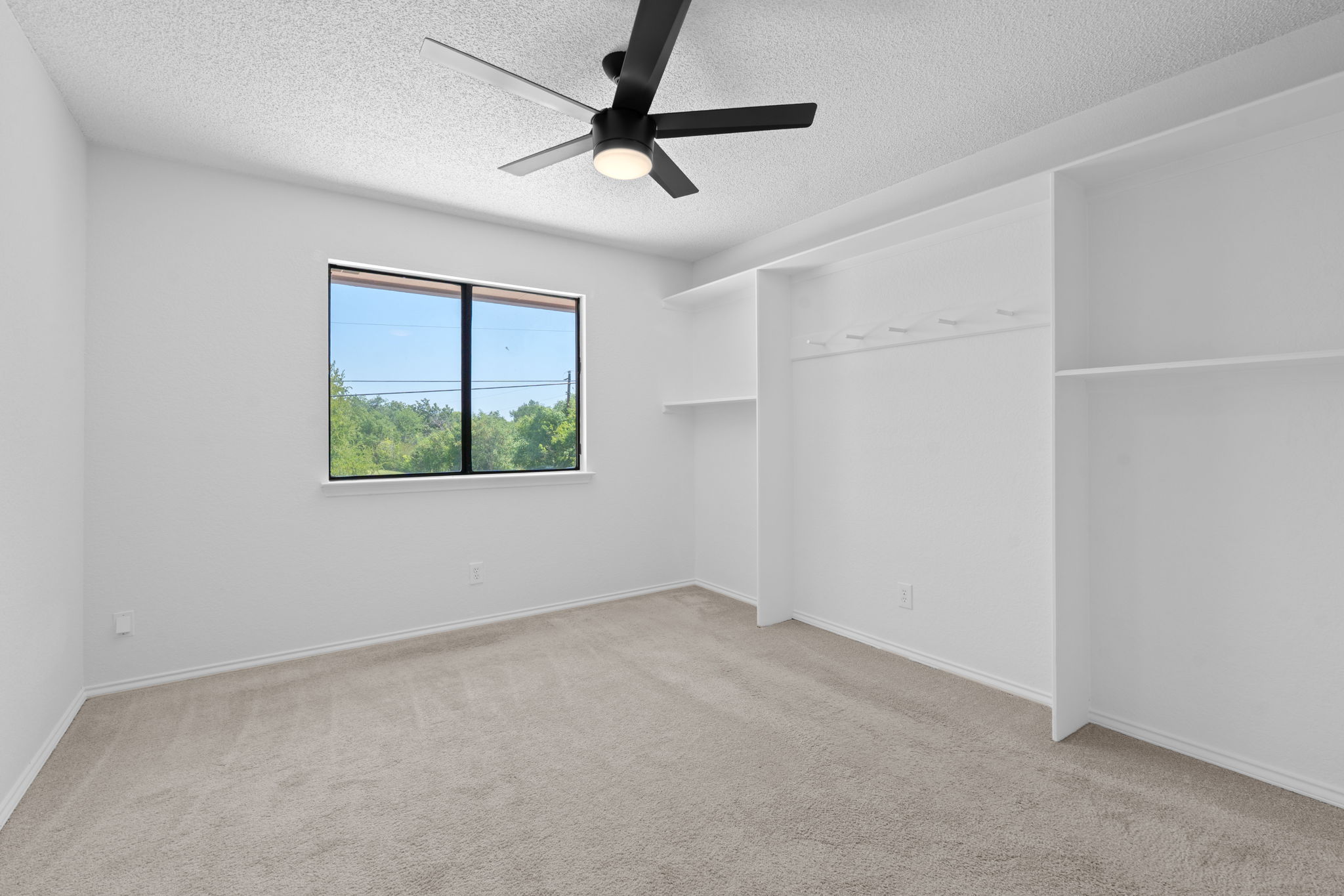 1106 Split Oak Cove Pflugerville, TX 78660 - Photo 17 of 25 an empty room with a window and a fan