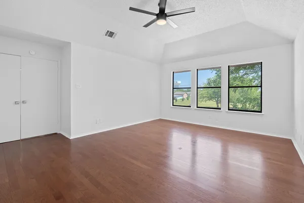 wooden floor in an empty room with a window