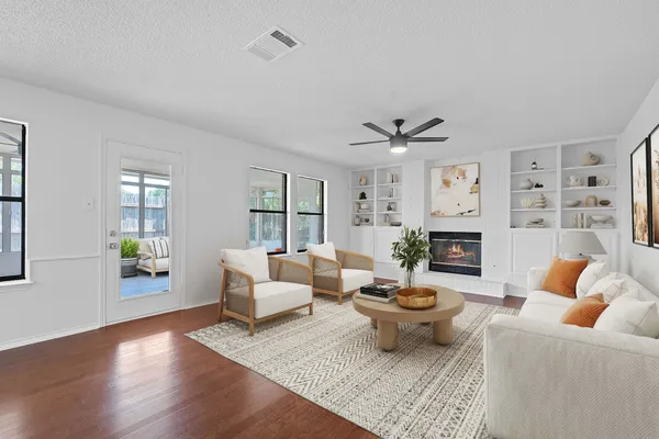 a living room with furniture a fireplace and a table