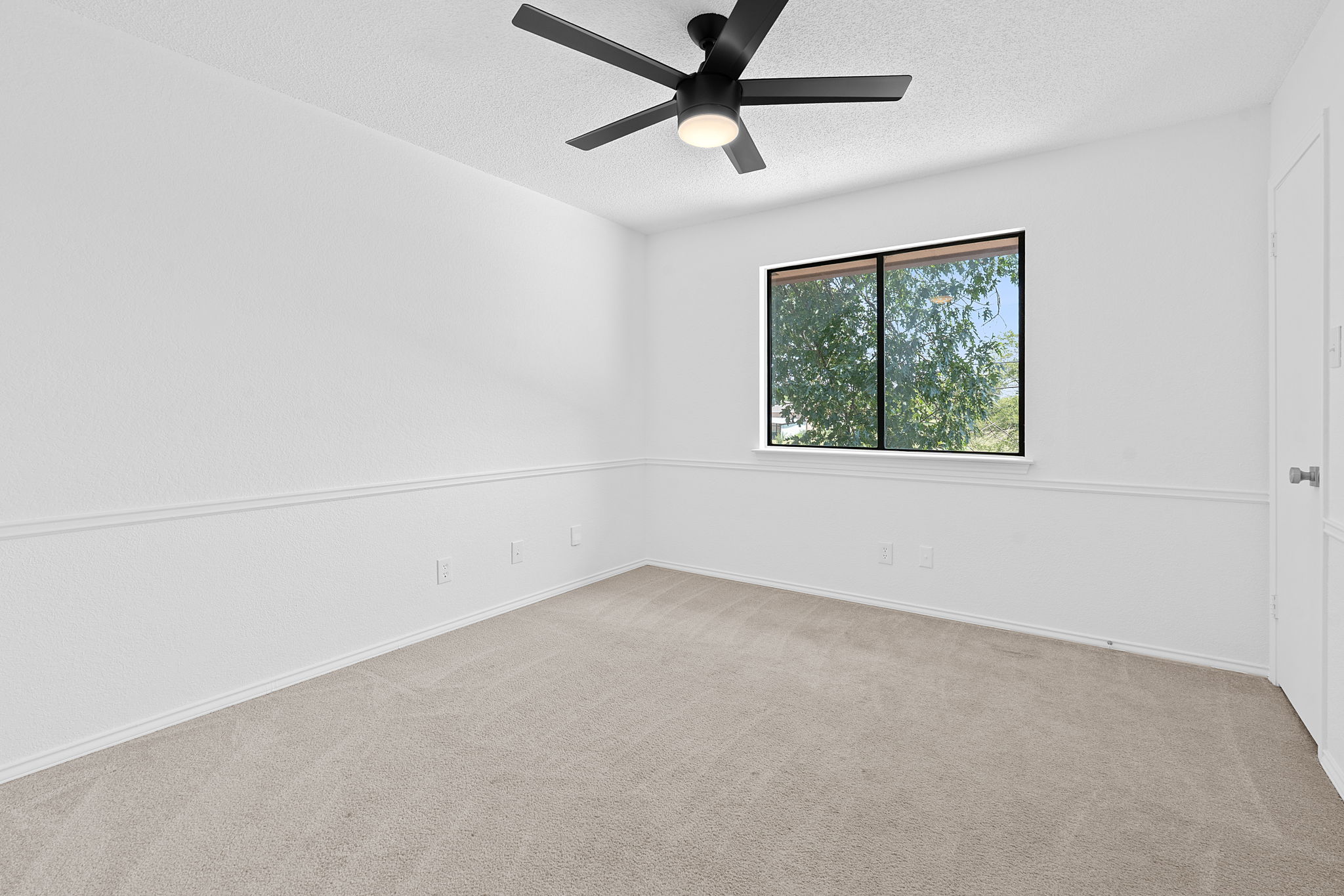 1106 Split Oak Cove Pflugerville, TX 78660 - Photo 25 of 27 an empty room with a window and a fan
