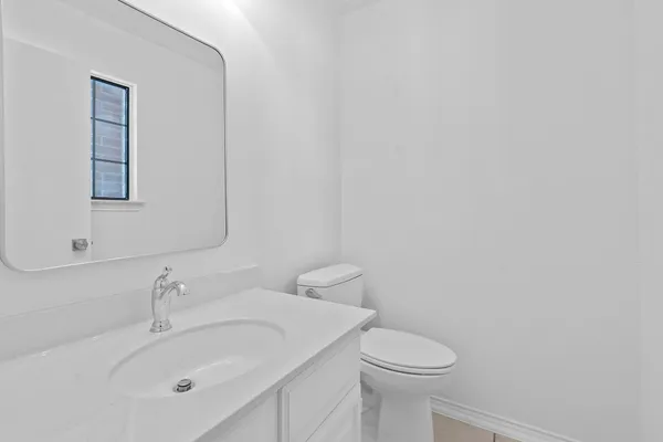a bathroom with a sink mirror and toilet