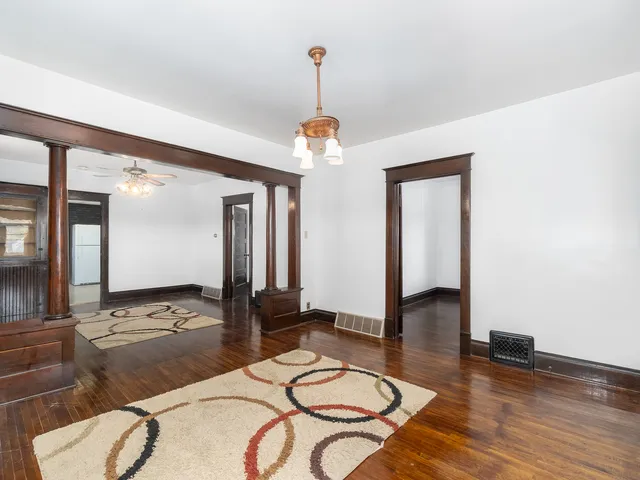 a living room with dining table and wooden floor