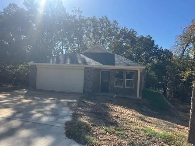 a view of a house with a yard and a tree
