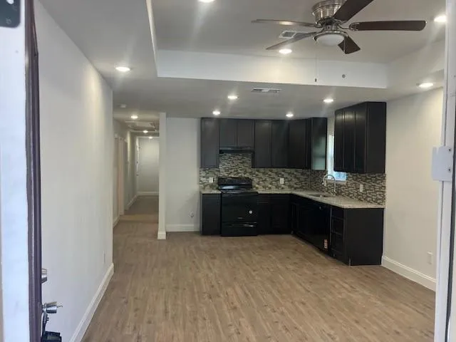 a large bathroom with a sink a vanity and a mirror