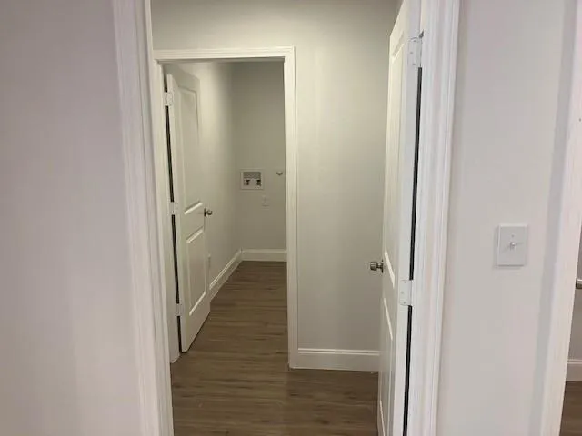 a view of a hallway with the wooden floor