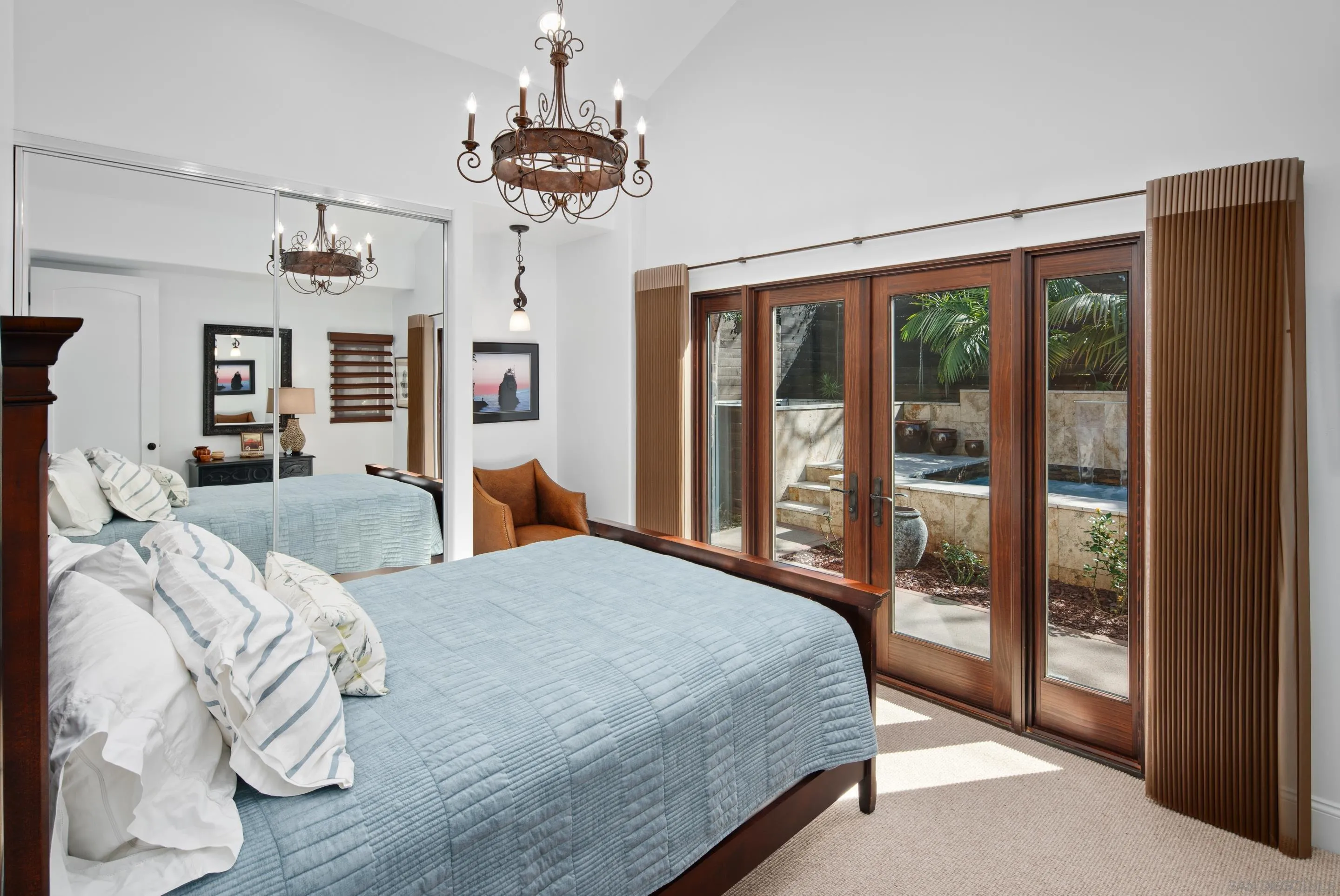 3537 Silvergate Place San Diego, CA 92106 - Photo 26 of 43 a bedroom with a large bed and a chandelier