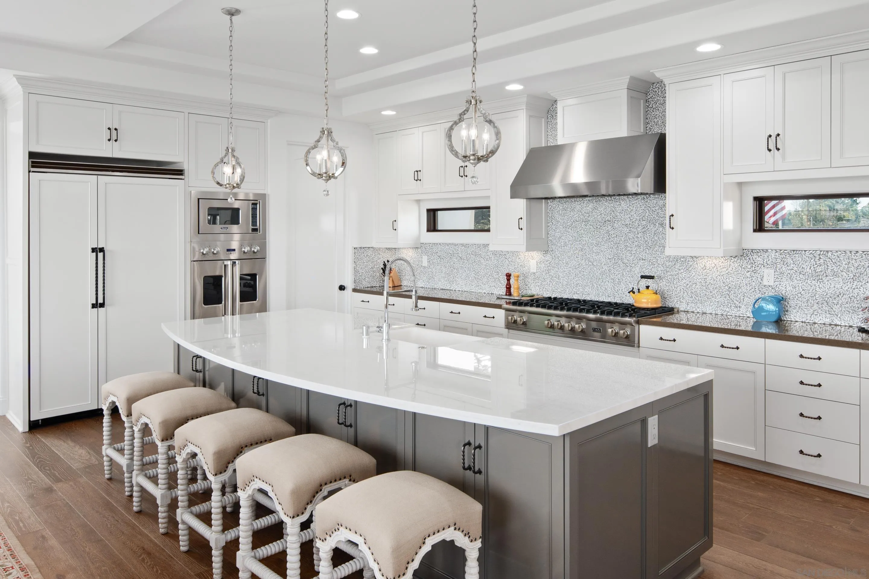 3537 Silvergate Place San Diego, CA 92106 - Photo 7 of 43 a kitchen with stainless steel appliances a table chairs and a refrigerator