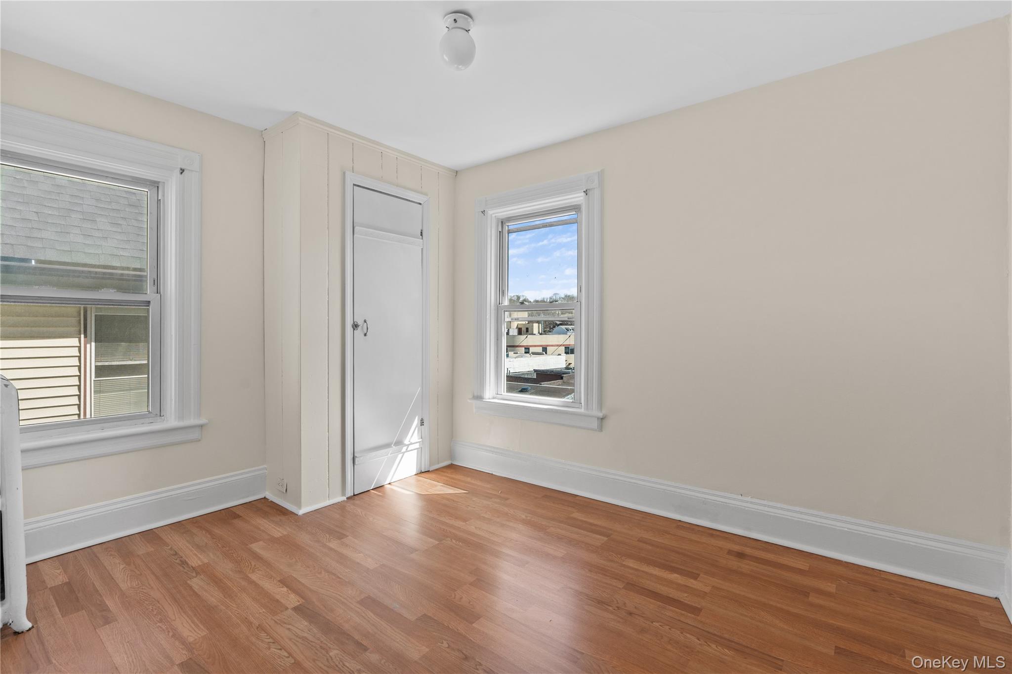 947 Diven Street Peekskill, NY 10566 - Photo 11 of 28 a view of an empty room with wooden floor and a window