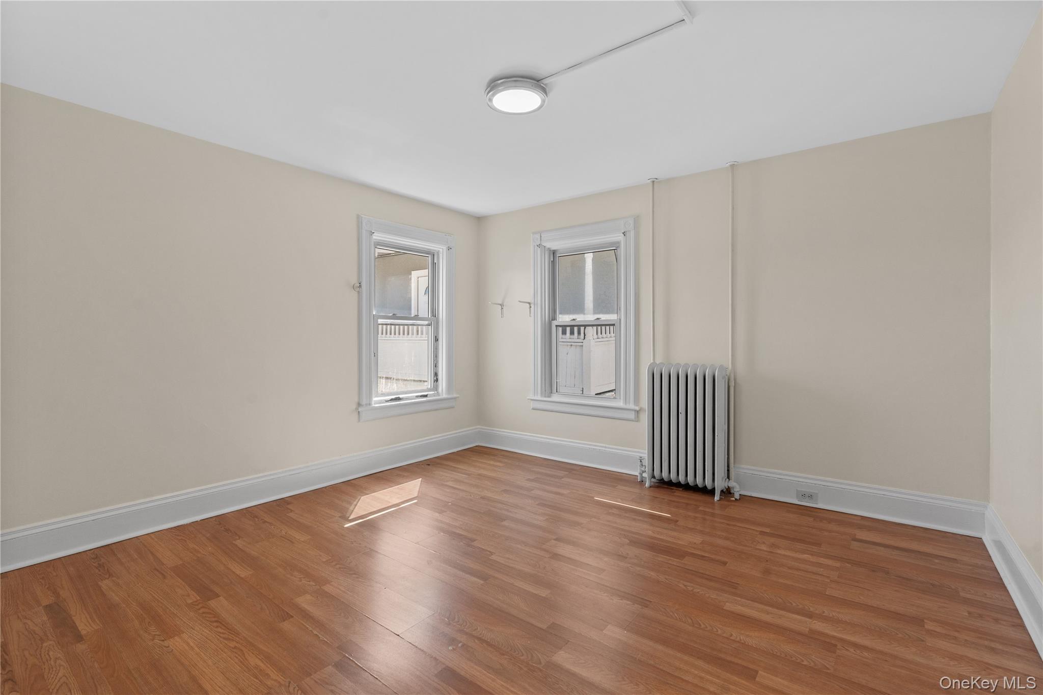 947 Diven Street Peekskill, NY 10566 - Photo 12 of 28 a view of an empty room with wooden floor and a window