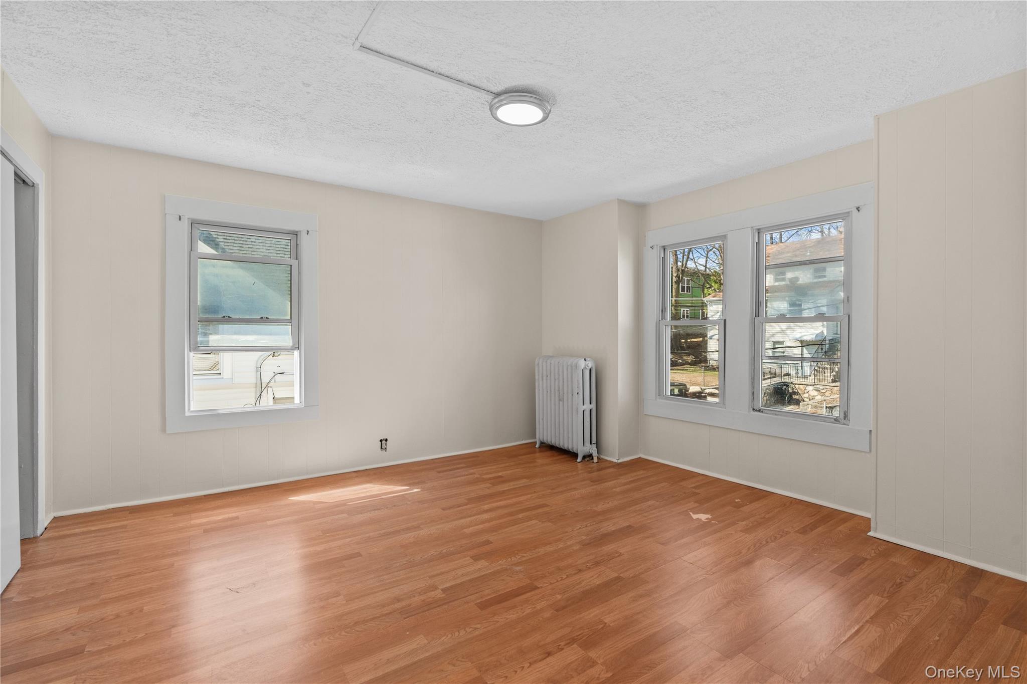 947 Diven Street Peekskill, NY 10566 - Photo 13 of 28 a view of an empty room with wooden floor and a window