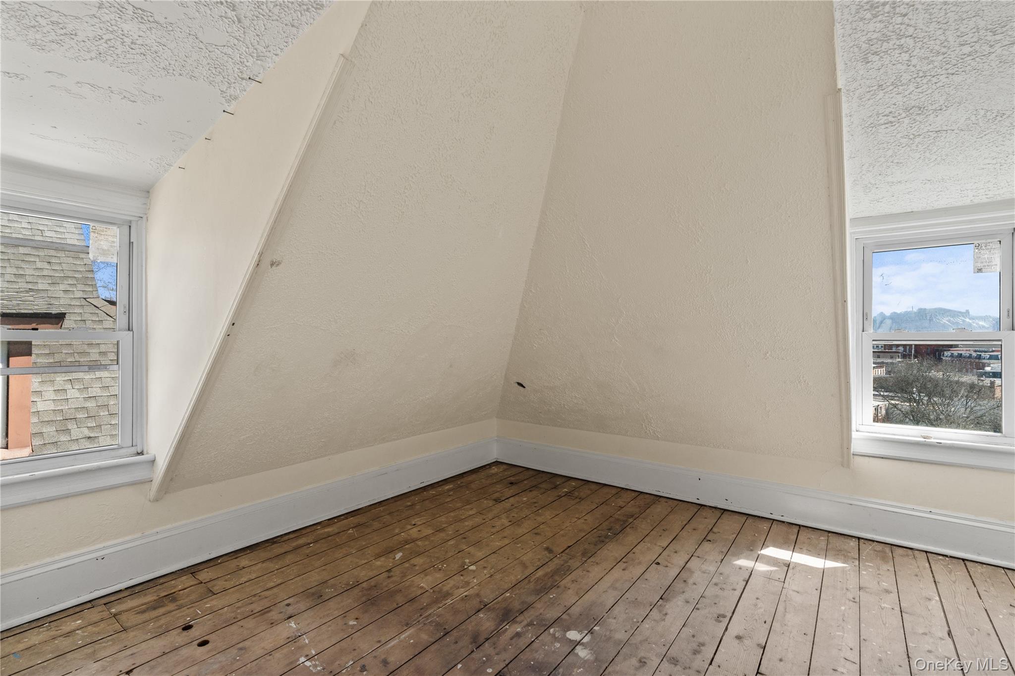947 Diven Street Peekskill, NY 10566 - Photo 16 of 28 an empty room with wooden floor and windows