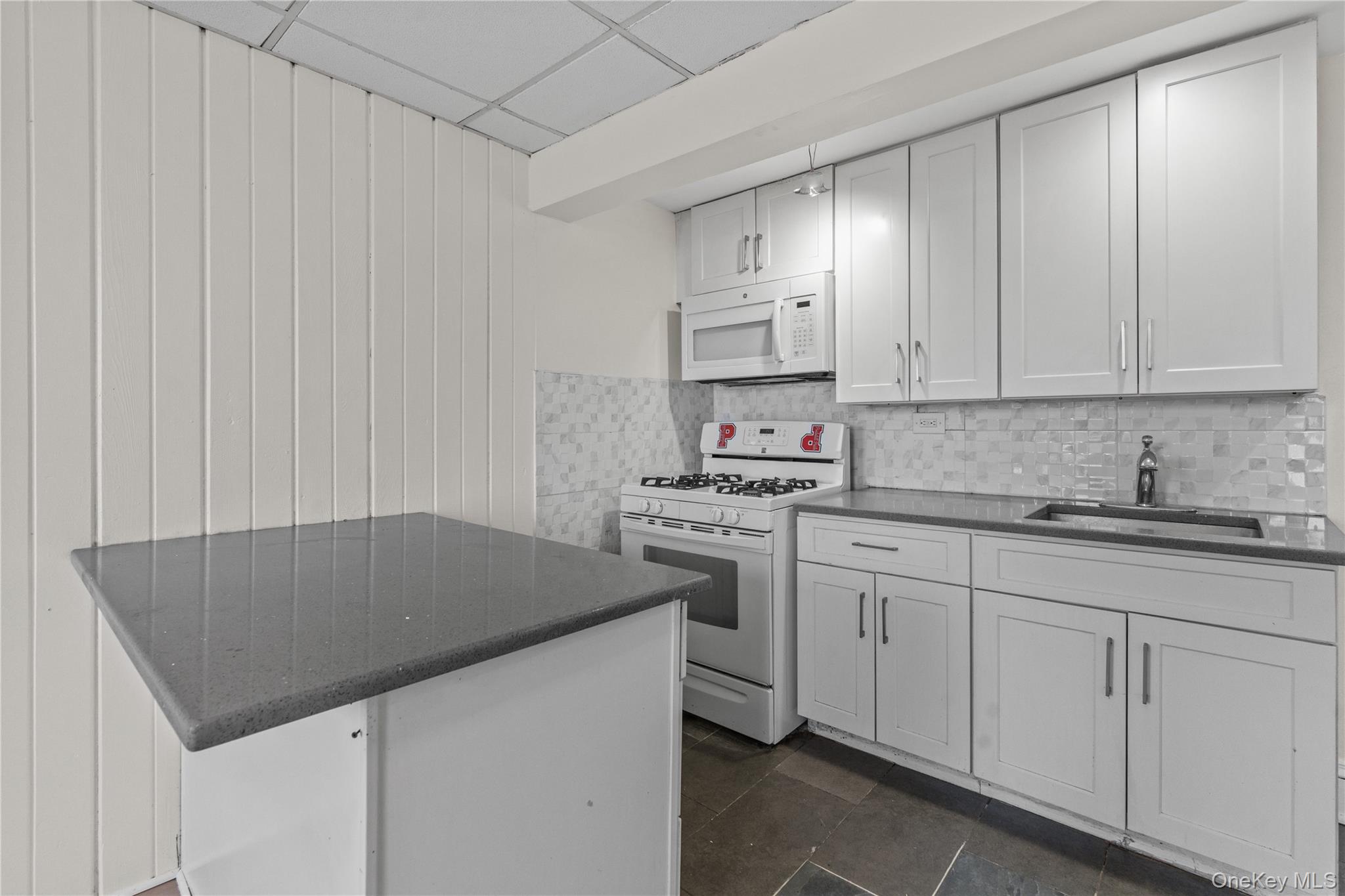 947 Diven Street Peekskill, NY 10566 - Photo 21 of 28 a kitchen with kitchen island sink stove and cabinets