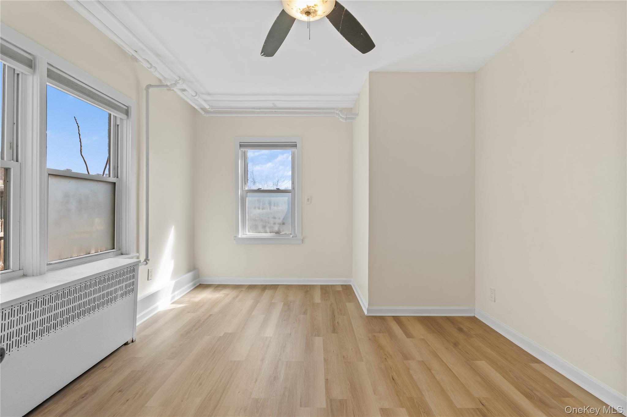 947 Diven Street Peekskill, NY 10566 - Photo 22 of 28 an empty room with a window and wooden floor