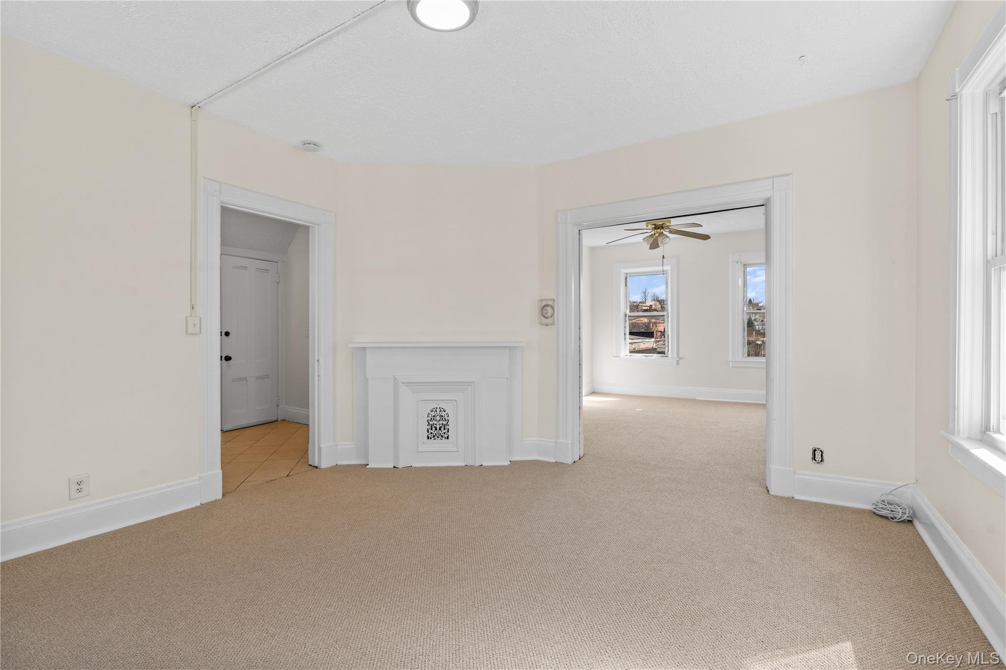 947 Diven Street Peekskill, NY 10566 - Photo 3 of 28 an empty room with windows and entrance to other room