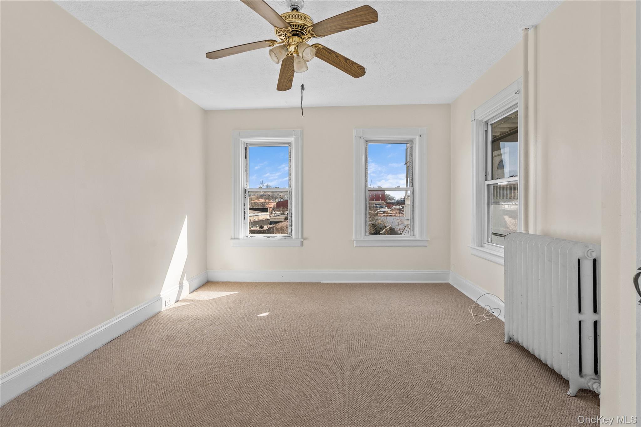947 Diven Street Peekskill, NY 10566 - Photo 6 of 28 an empty room with windows and fan