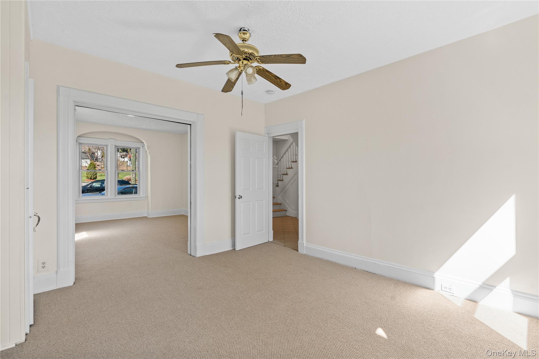 947 Diven Street Peekskill, NY 10566 - Photo 7 of 28 a view of a livingroom with a ceiling fan and wooden floor