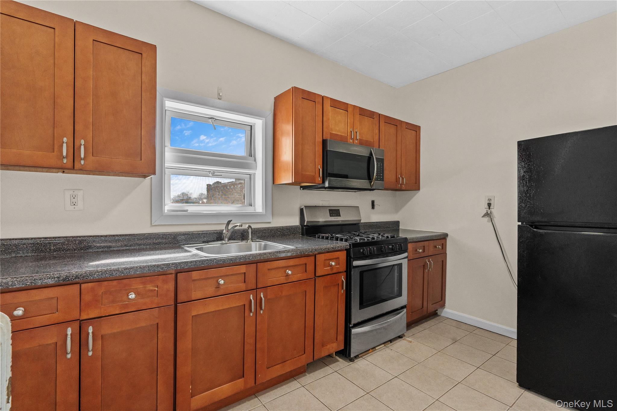 947 Diven Street Peekskill, NY 10566 - Photo 8 of 28 a kitchen with stainless steel appliances granite countertop a refrigerator stove and sink