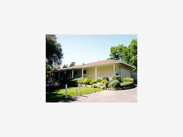 126 Hames Road Watsonville, CA 95076 - Photo 1 of 1 a view of a house with a yard and table and chairs under an umbrella