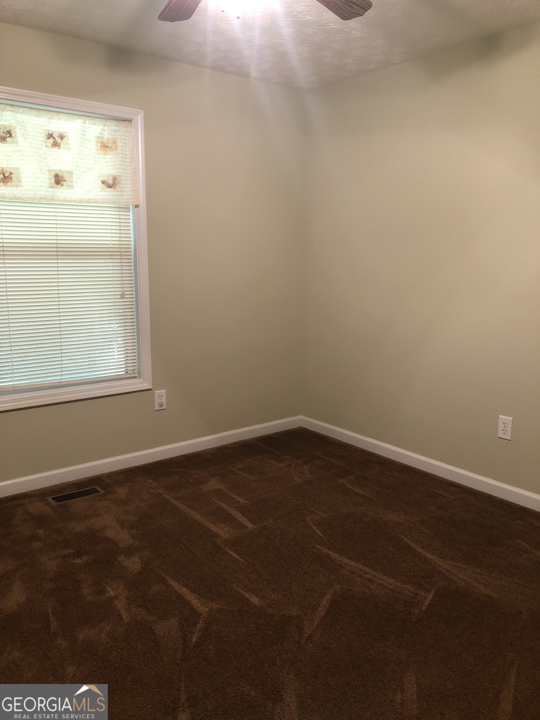 1744 Campbell Road Covington, GA 30014 - Photo 12 of 29 an empty room with a empty space and a window