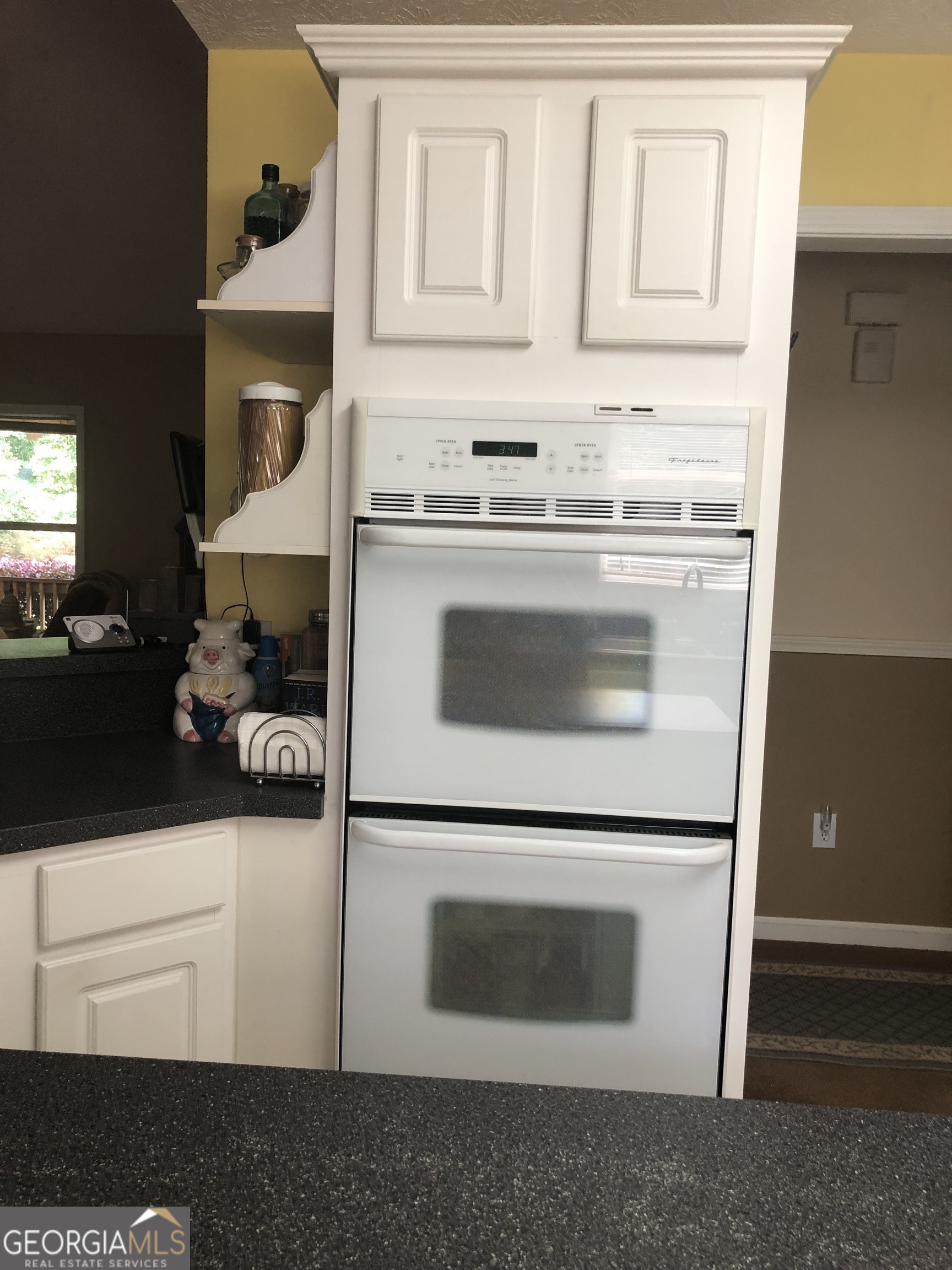 1744 Campbell Road Covington, GA 30014 - Photo 6 of 29 a kitchen with granite countertop white cabinets and white appliances