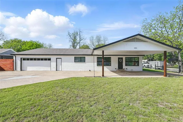 a front view of a house with a yard and porch