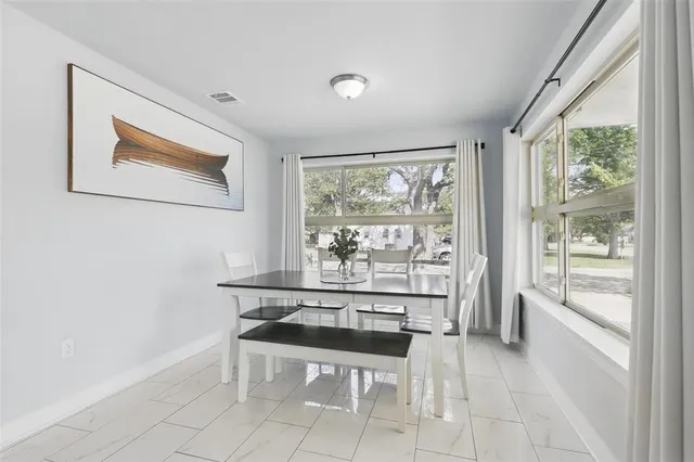 a dining room with a large window and bed