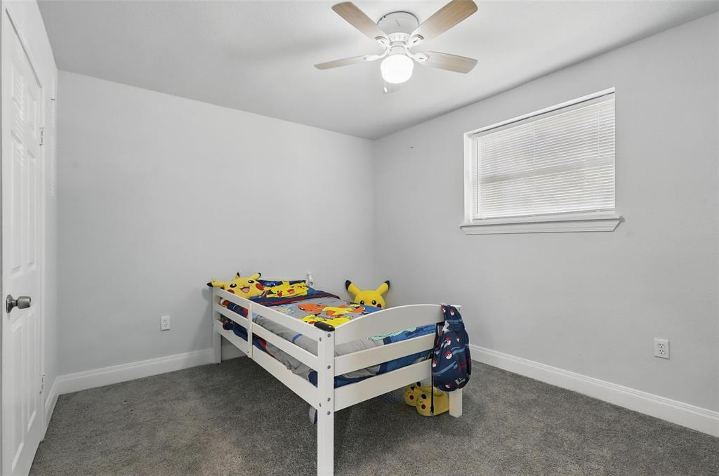 5200 Barbara Road River Oaks, TX 76114 - Photo 13 of 40 a bedroom with a bed and a chandelier