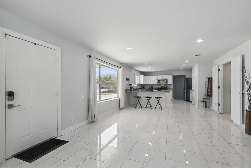 5200 Barbara Road River Oaks, TX 76114 - Photo 15 of 40 a view of a livingroom with table & chairs a ceiling fan and entryway