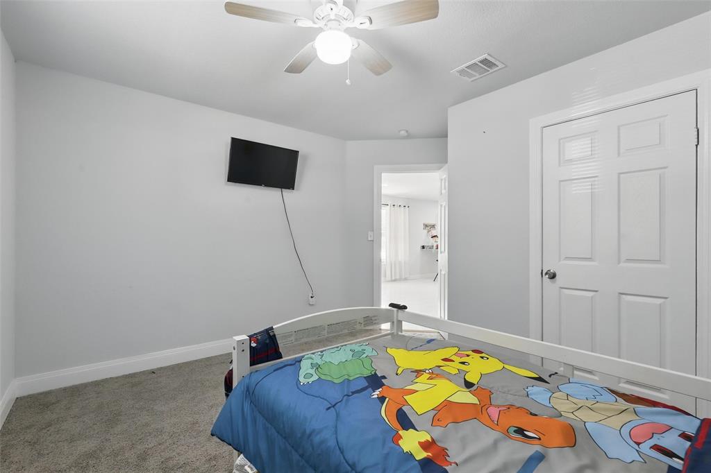 5200 Barbara Road River Oaks, TX 76114 - Photo 16 of 40 a bed room with a bed and a chandelier