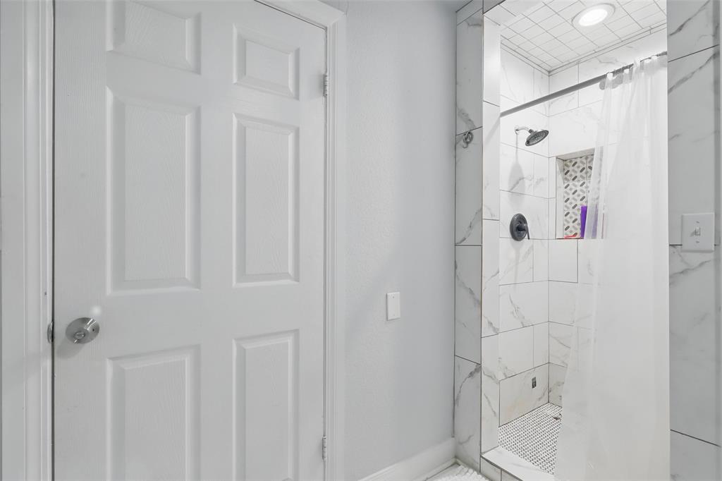 5200 Barbara Road River Oaks, TX 76114 - Photo 18 of 40 a bathroom with a shower and a toilet