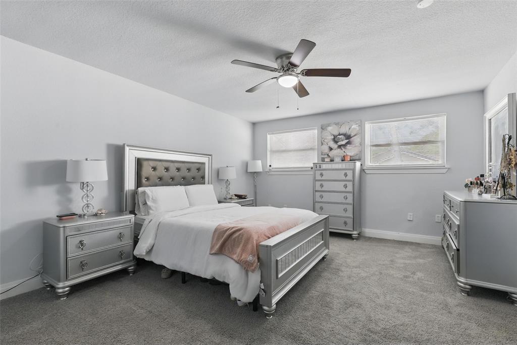 5200 Barbara Road River Oaks, TX 76114 - Photo 25 of 40 a spacious bedroom with a bed and a desk