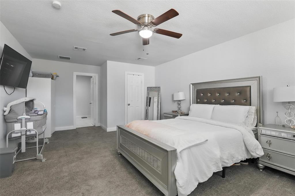 5200 Barbara Road River Oaks, TX 76114 - Photo 26 of 40 a bedroom with a bed and a chandelier
