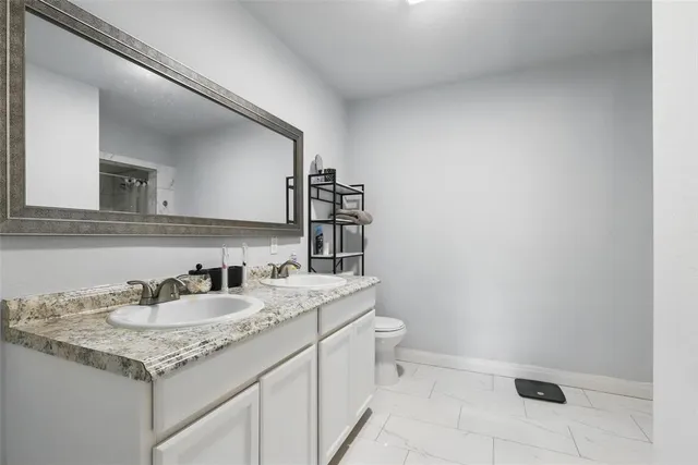 a bathroom with a glass shower door