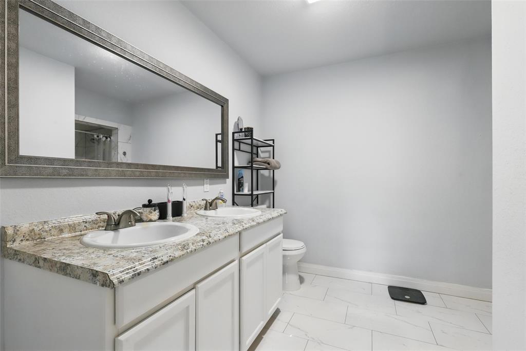 5200 Barbara Road River Oaks, TX 76114 - Photo 27 of 40 a bathroom with a sink and a toilet