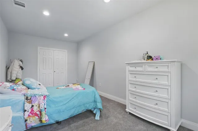 a living room with furniture and a dresser