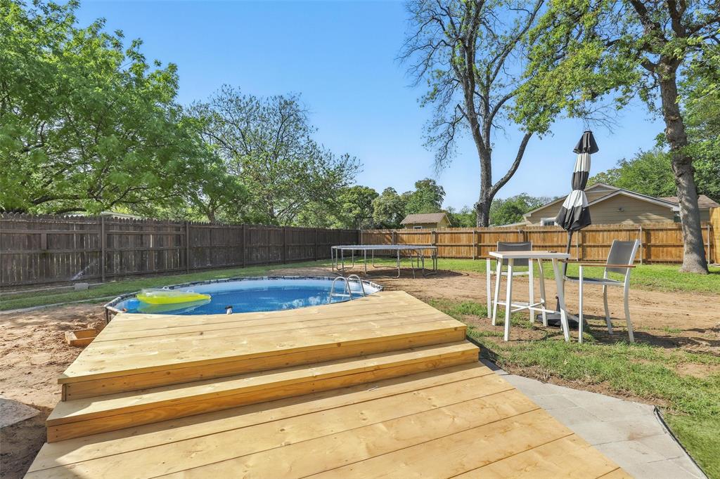 5200 Barbara Road River Oaks, TX 76114 - Photo 37 of 40 a view of swimming pool with wooden fence