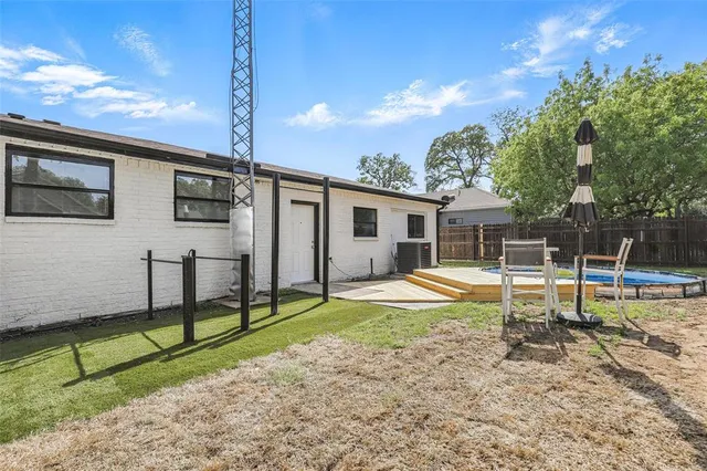a front view of a house with garden and trees