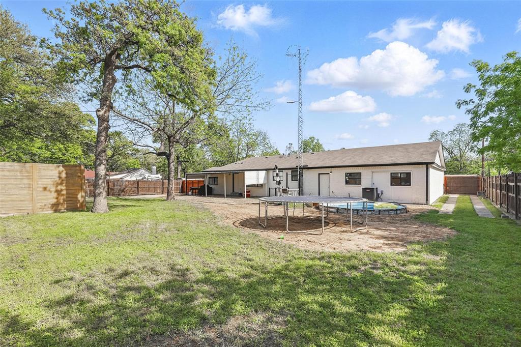 5200 Barbara Road River Oaks, TX 76114 - Photo 39 of 40 a front view of a house with garden and trees