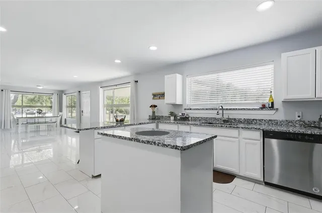 a kitchen with sink stove and cabinets