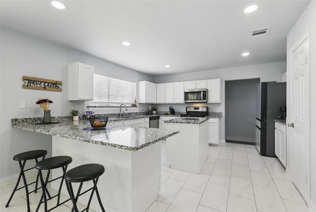 5200 Barbara Road River Oaks, TX 76114 - Photo 6 of 40 a kitchen with stainless steel appliances granite countertop a refrigerator sink and cabinets