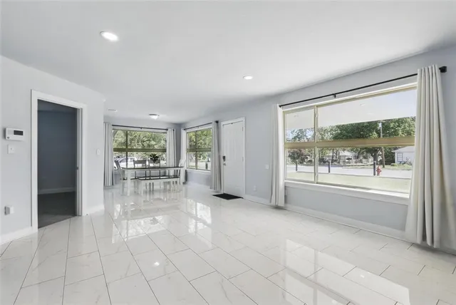 a room with natural light and glass door