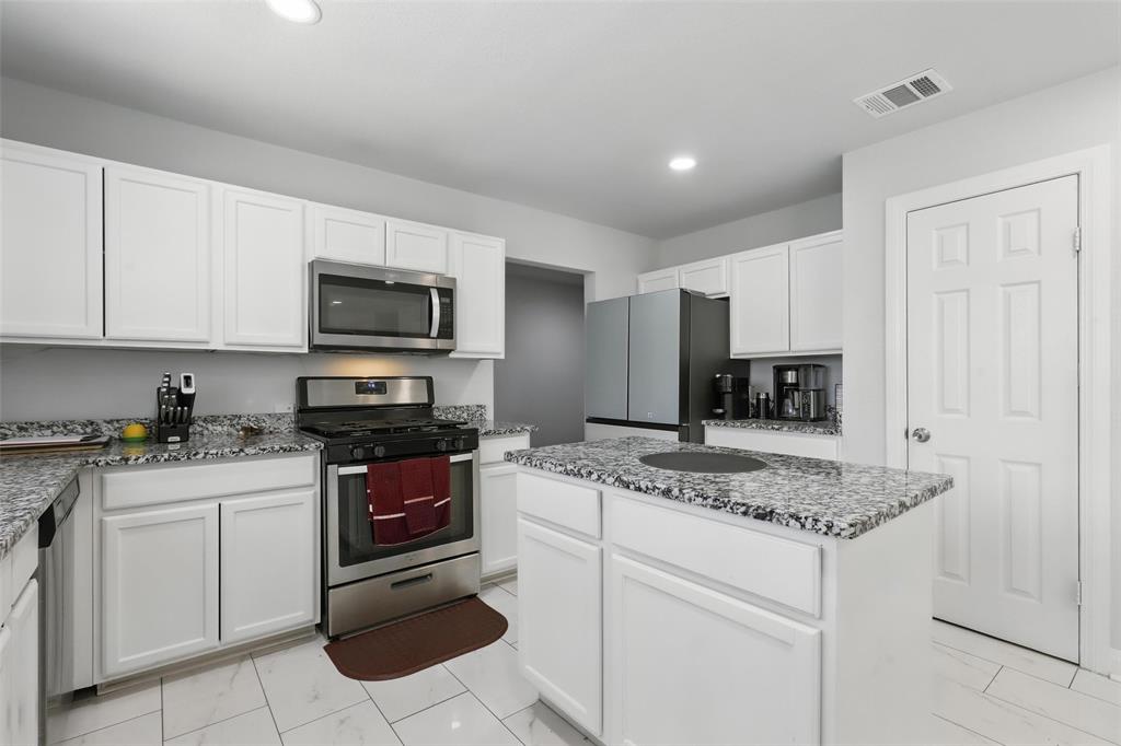 5200 Barbara Road River Oaks, TX 76114 - Photo 9 of 40 a kitchen with stainless steel appliances granite countertop a sink stove and microwave