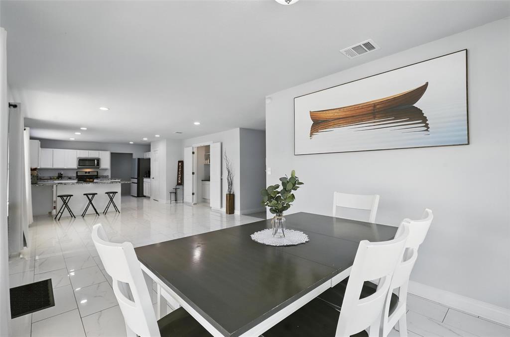 5200 Barbara Road River Oaks, TX 76114 - Photo 10 of 40 a view of a dining room with furniture and wooden floor