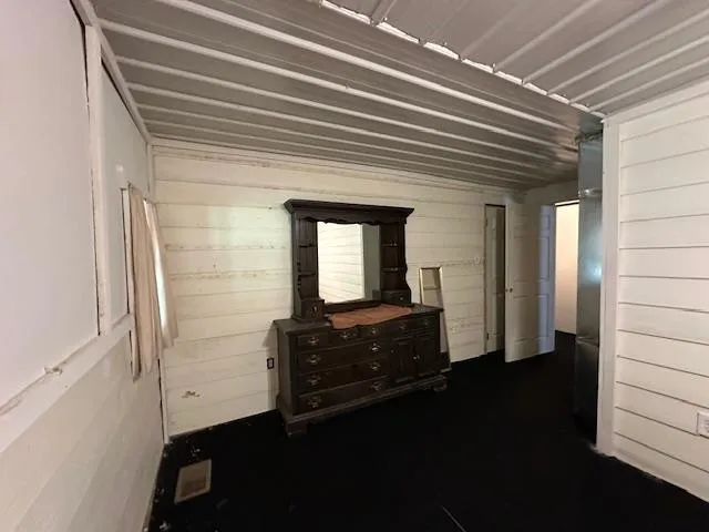 a living room with couches chairs and a large window with wooden floor