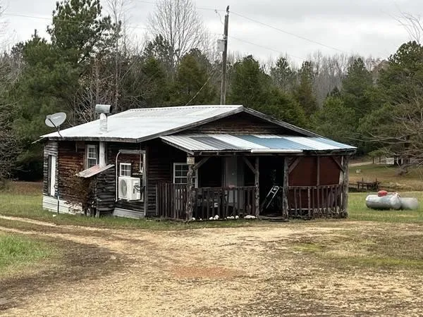 a view of a porch with furniture and a yard