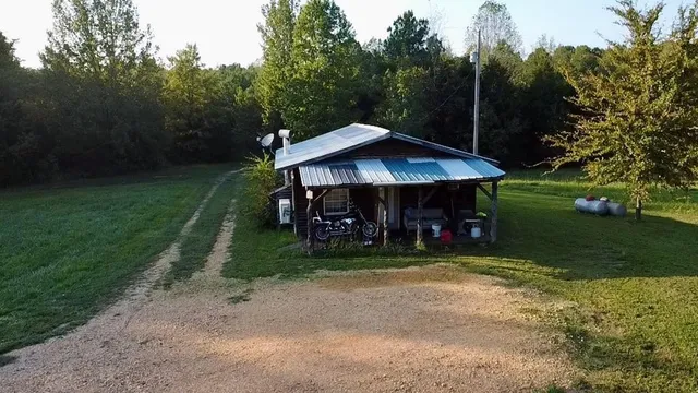 a view of a field of grass and trees