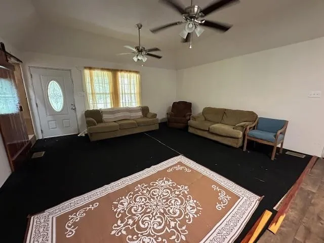 a view of a livingroom with furniture and windows